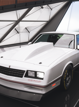 Modified white 1988 Chevrolet Monte Carlo Super Sport viewed from front left angle showing classic boxy muscle car styling with distinctive grille and angular headlights